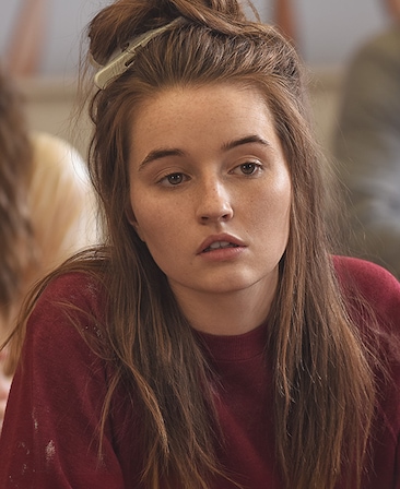 Kaitlyn Dever headshot wearing a red sweater and clip in her hair