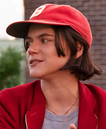 Soko headshot wearing a red baseball cap and red jacket with gray shirt