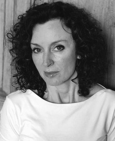 Gillian Berrie headshot wearing a white top in black and white filter