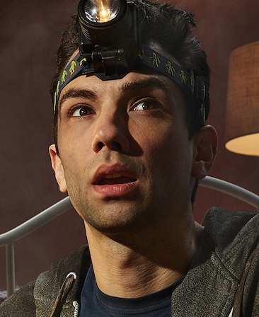 Jay Baruchel headshot with a flashlight strapped to his head and wearing a black shirt
