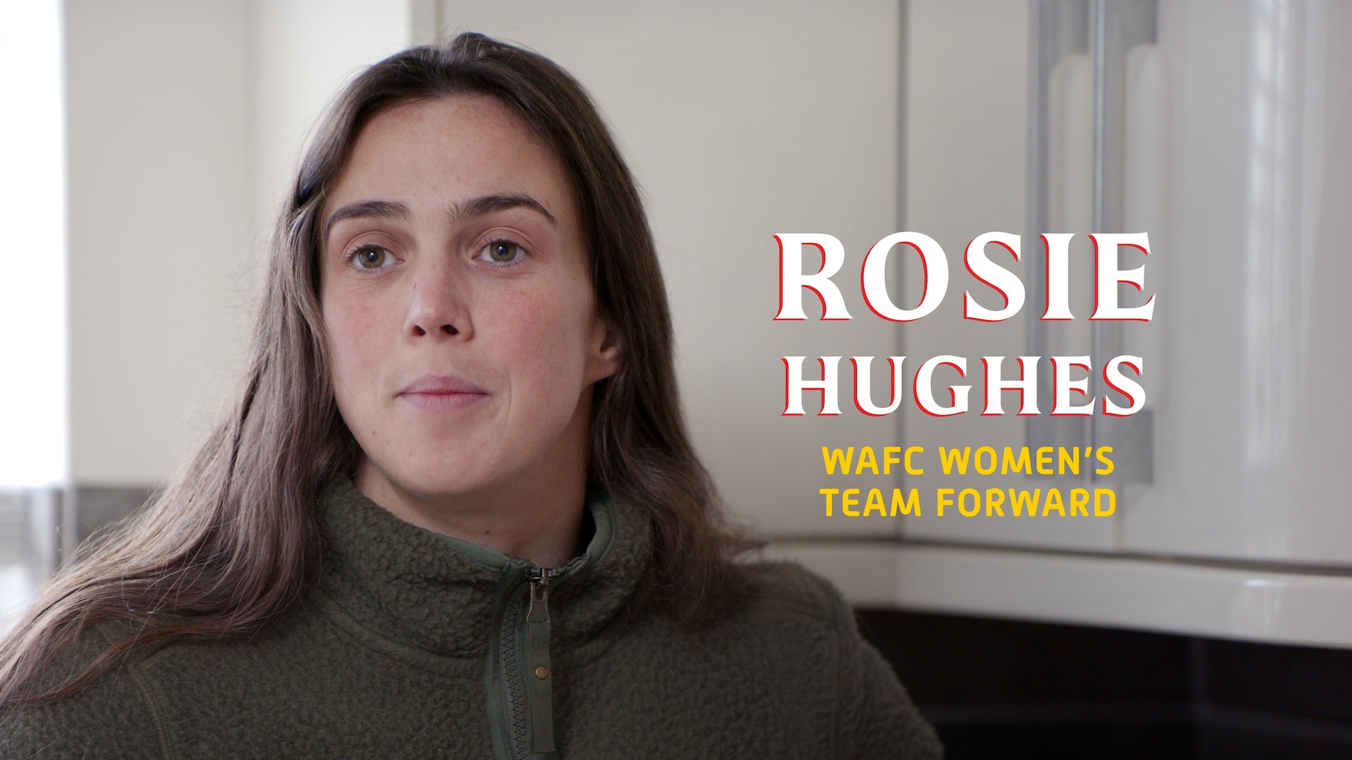 Rosie Hughes headshot wearing a green zip up sherpa jacket, with her name in large white text.