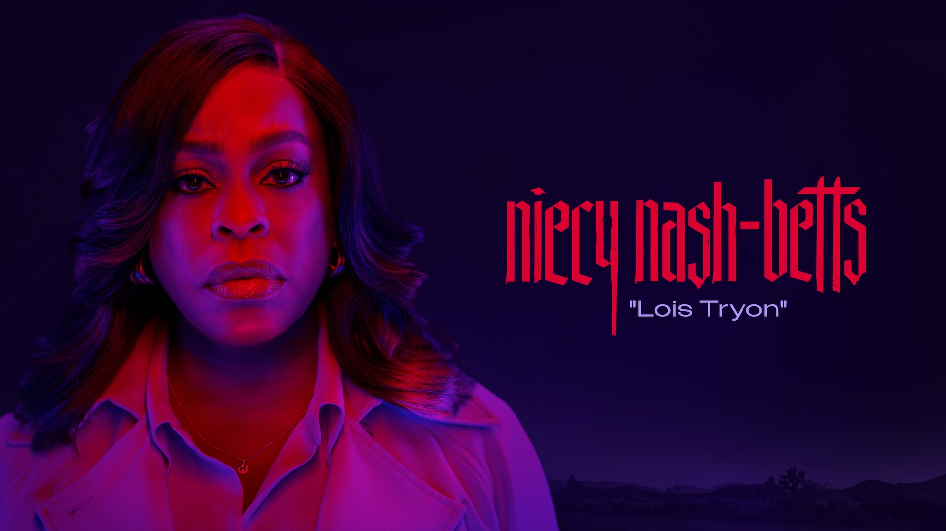 Niecy Nash-Betts as Lois Tryon in FX's Grotesquerie in a button up and coat with pink and purple lights shone on her face.