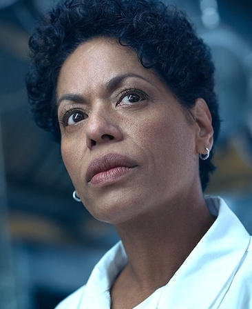 Liza Colón-Zayas headshot wearing a white collared shirt.