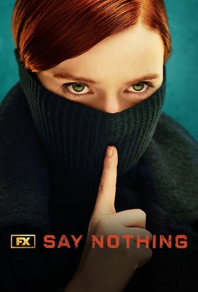 Woman with red hair and green eyes wearing a black turtleneck over her face and shushing.