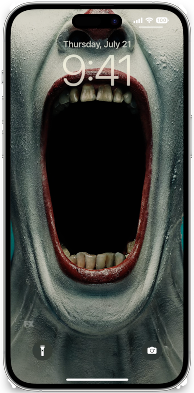 iPhone lock screen of clown wearing white makeup and red lipstick opening jaw wide open from FX's AHS Freak Show