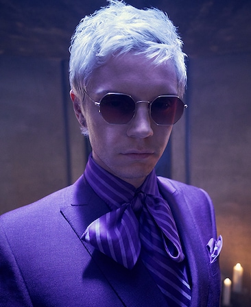 Evan Peters headshot in purple suit and purple bowtie and sunglasses from AHS Apocalypse