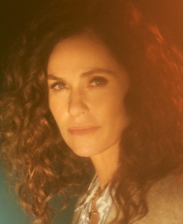Amy Brenneman headshot wearing collar shirt and sweater