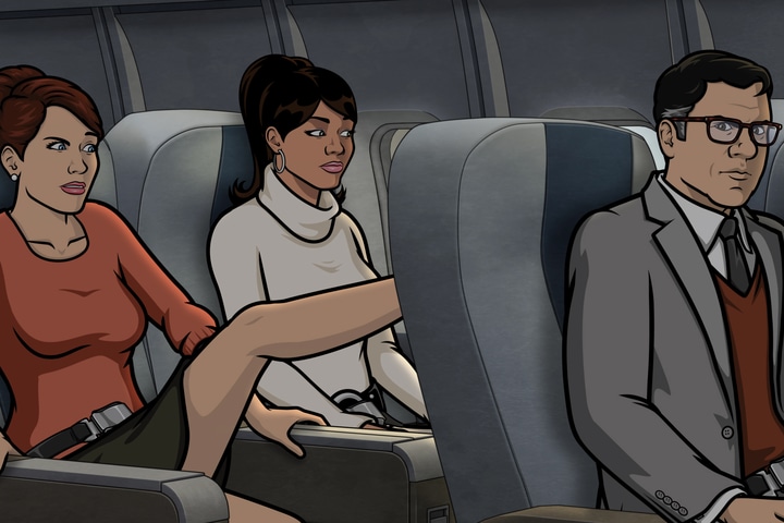 Cheryl kicks the back of the seat of Cyril while sitting next to Lana on airplane 