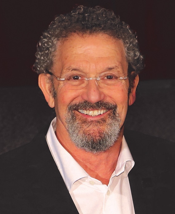 Thomas Schlamme Headshot wearing a white button down and black jacket