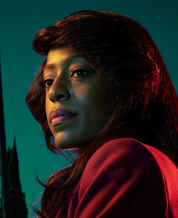 Devyn Tyler headshot wearing a red jacket 