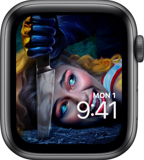 Apple Watch lock screen of a woman laying on the ground screaming as a hand pierces the ground next to her.