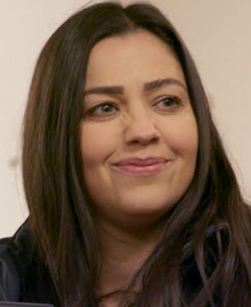 Gemma Owen headshot wearing a black top standing against a white background
