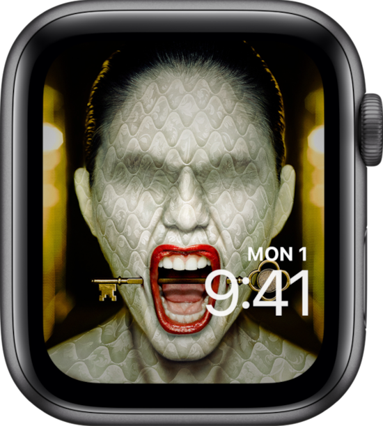 Apple Watch lock screen of woman with mattress texture skin with hotel key through mouth from FX's AHS Hotel