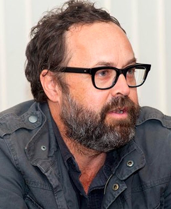 Scott Robertson headshot in a grey jacket and black glasses.