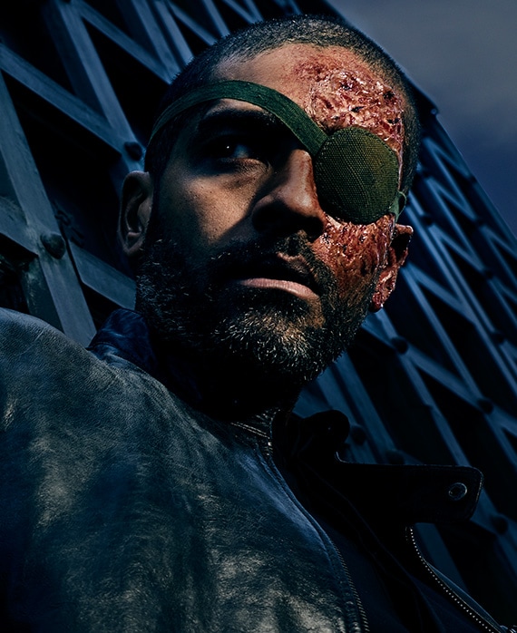 Alexander Karim headshot with bloody face and eye patch over one eye 