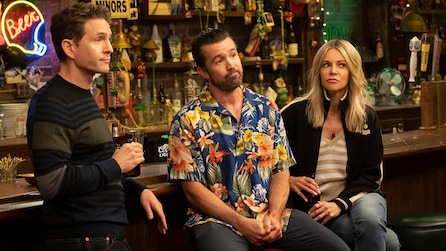 Dennis with drink, Mac in blue Hawaiian shirt, and Sweet Dee looking suspiciously at the front in FX's It's Always Sunny
