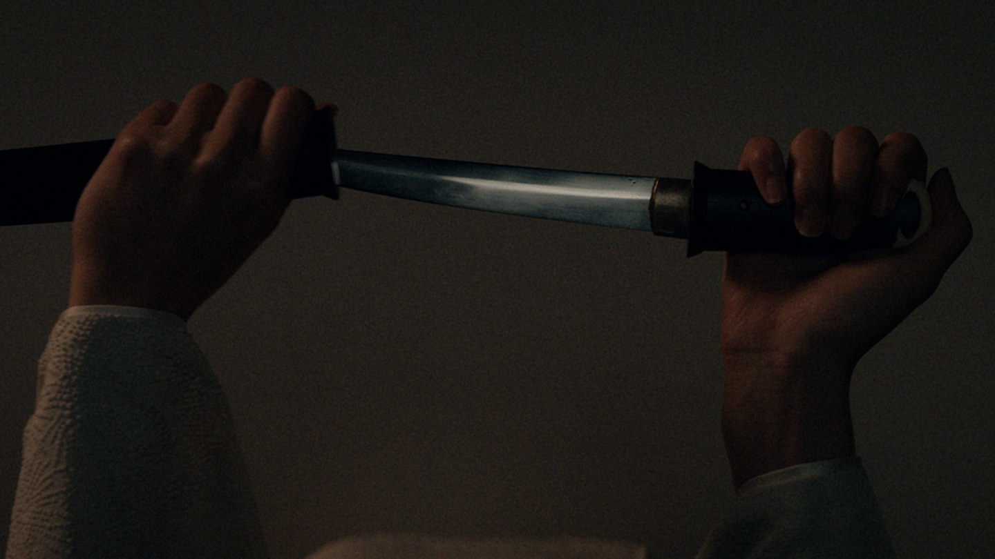 Close up of a kaiken being removed from its sheath