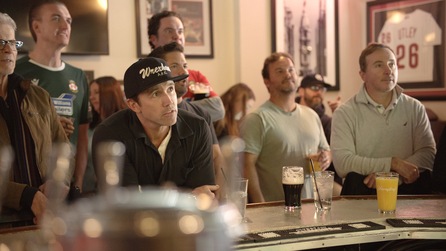 Group of men sitting at a bar looking up