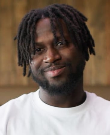 Jacob Mendy headshot wearing a white shirt, standing in front of a neutral background