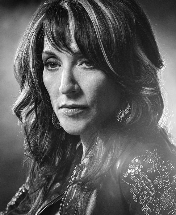 Katey Segal headshot wearing a bedazzled jacket with highlights in her hair