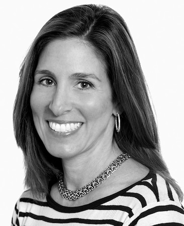 Black and white headshot of Carolyn Bernstein in black and white striped shirt with plain white background