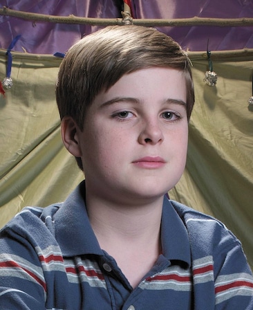 Aidan Mitchell headshot wearing a blue and red stripe polo shirt