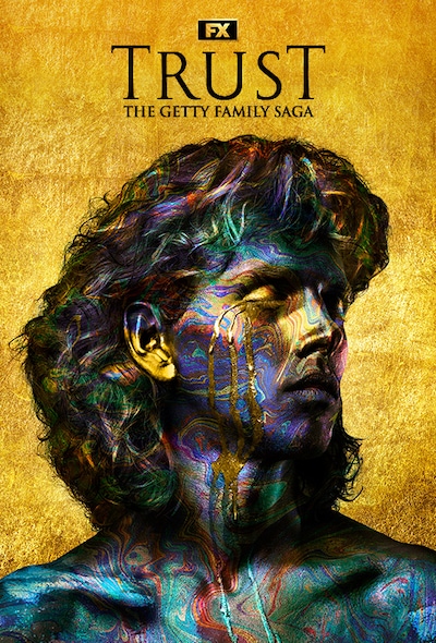 Close up of man's face and long hair covered in swirls of colorful paint with golden tears streaming down face for FX's Trust