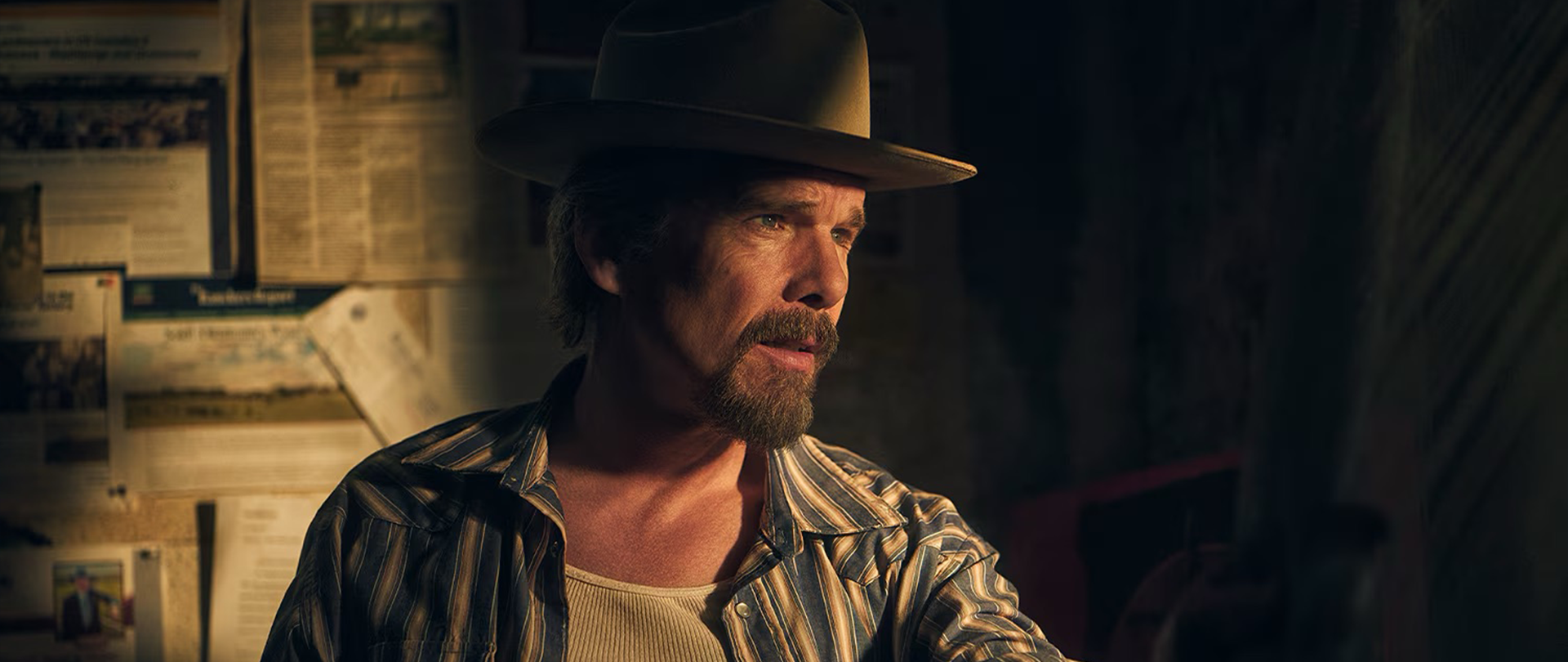 Ethan Hawke wearing a striped shirt and brown hat for FX's The Lowdown.
