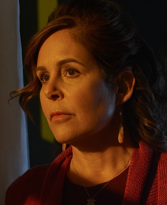 Laura Niemi headshot wearing a red sweater 