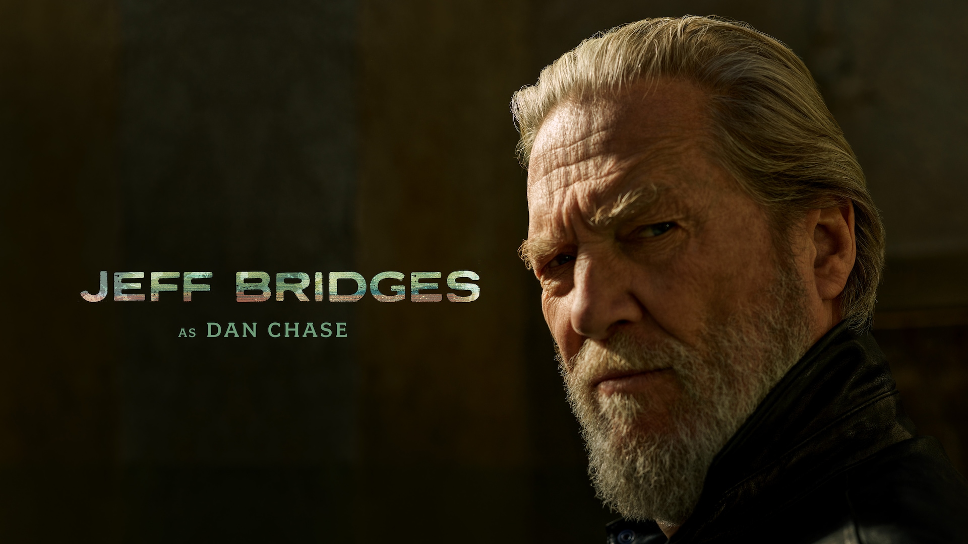 Jeff Bridges headshot wearing black jacket in the outdoors