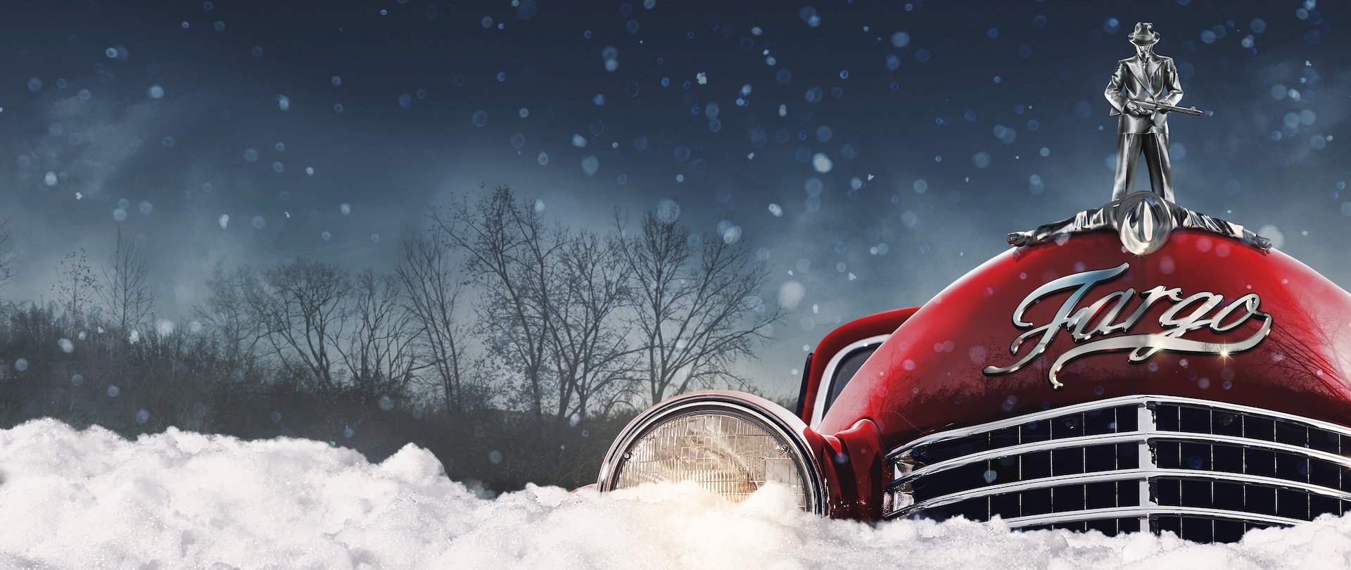 Front of red classic car caught in a snow drift with headlights on and a silver hood ornament of a mobster with a gun.