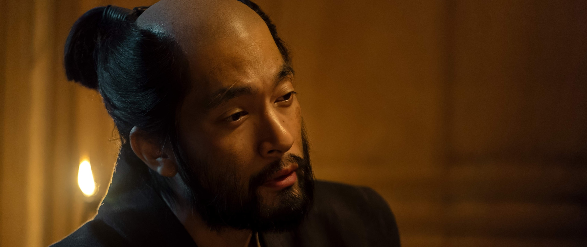 Close up of Buntaro dimly light by torch light in FX’s Shogun