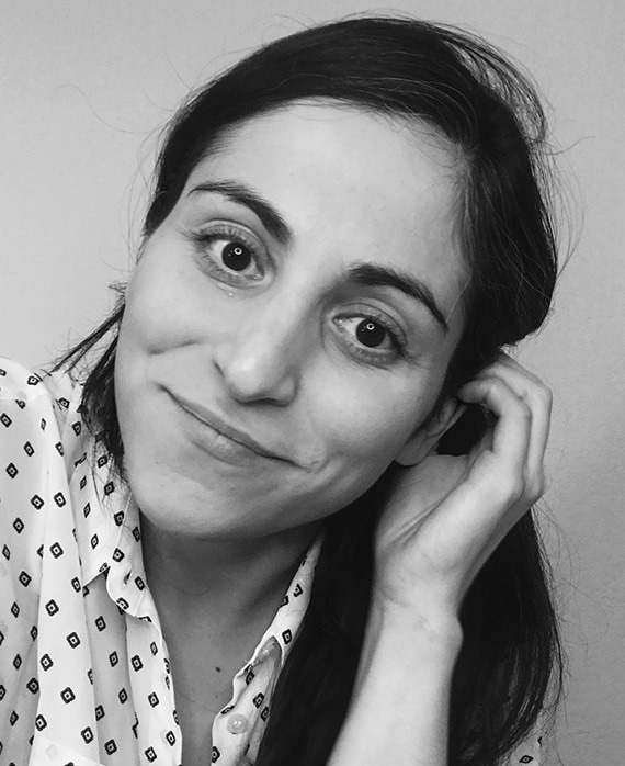 Black and white headshot of executive producer Sarah Naftalis, wearing a white patterned blouse. 