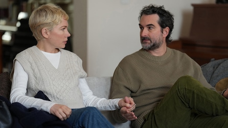 Molly and Steve sitting next to each other while holding hands. 