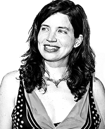 Jamie Babbit headshot wearing a polka dot blouse and necklace
