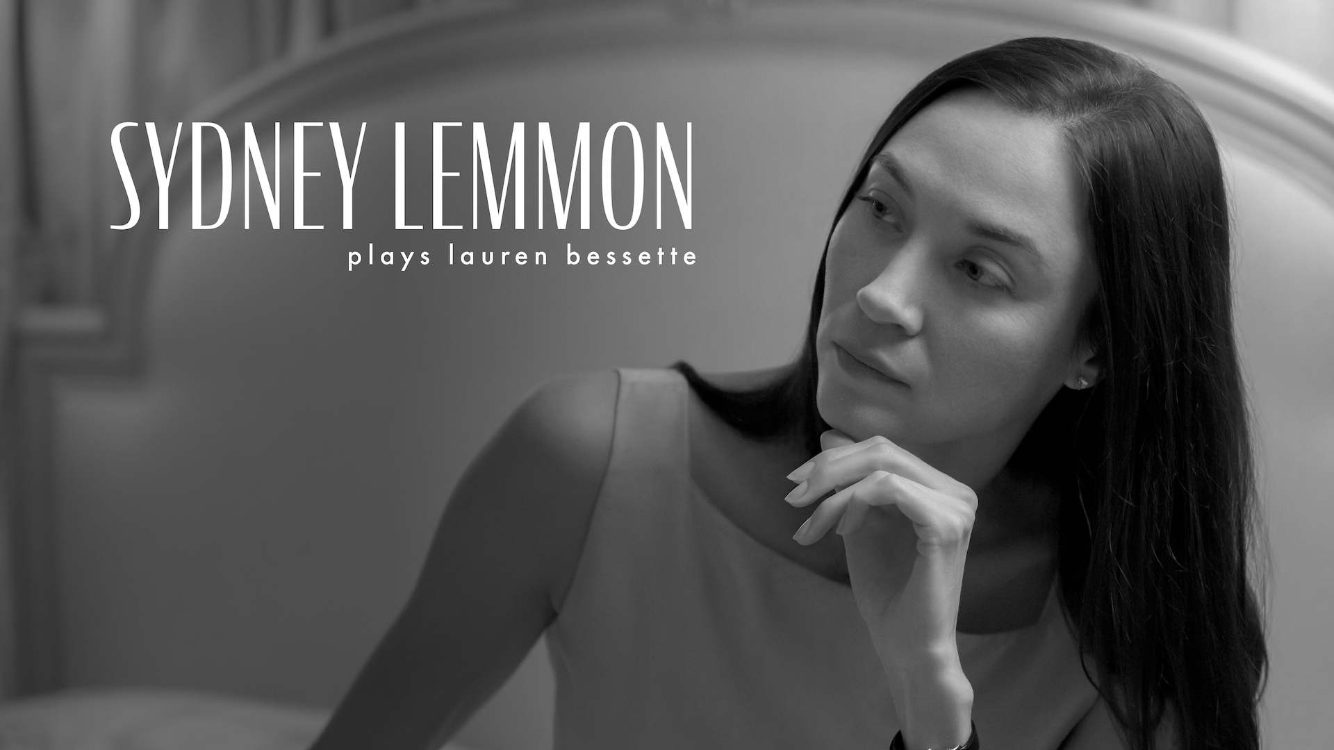 Black and white headshot of Sydney Lemmon as Lauren Bessette in FX's Love Story wearing a square cut blouse.