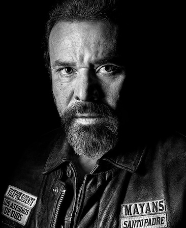 Michael Irby headshot wearing a mayans Santo Padre leather jacket 