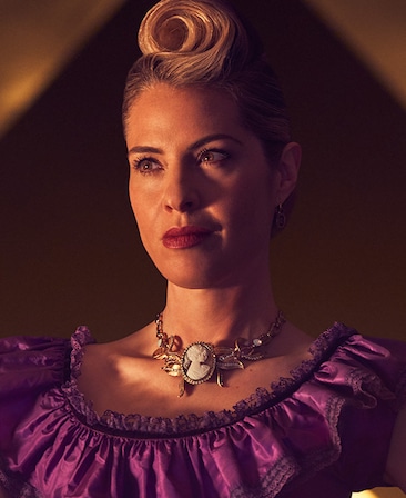 Leslie Grossman headshot in purple dress with golden detailed necklace from American Horror Story Apocalypse