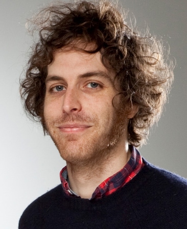 Headshot of executive producer Jonathan Krisel, wearing a black sweater with a colorful shirt underneath.