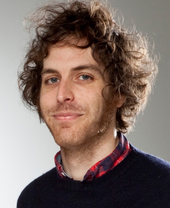 Headshot of executive producer Jonathan Krisel, wearing a black sweater with a colorful shirt underneath.