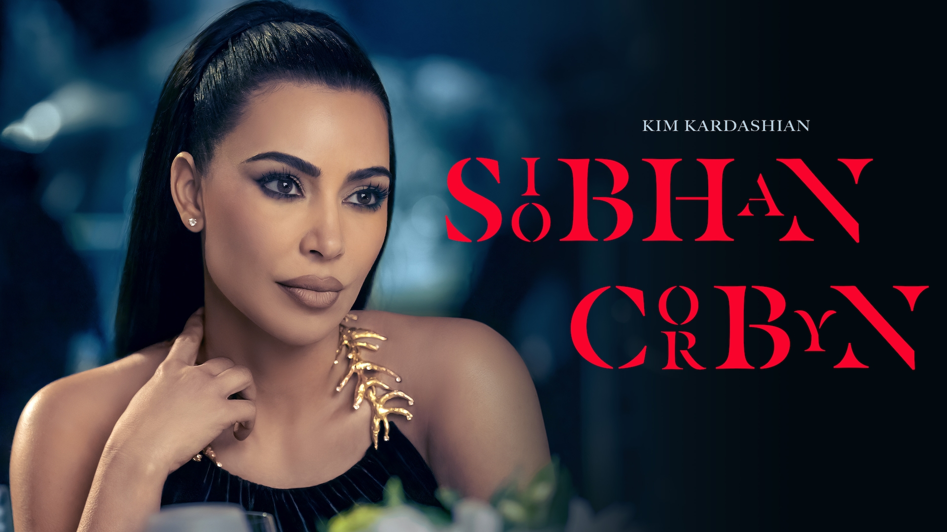 Kim Kardashian headshot wearing a black top with gold metal detailing for AHS: Delicate