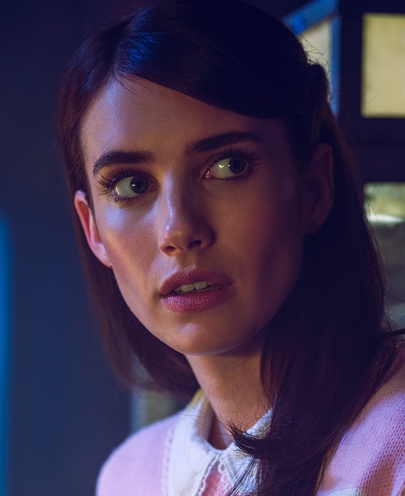 Emma Roberts headshot with hair down in pink dress and white collar from American Horror Story 1984