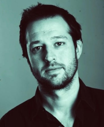 Dave Andron Headshot wearing a black shirt with a green effect over image