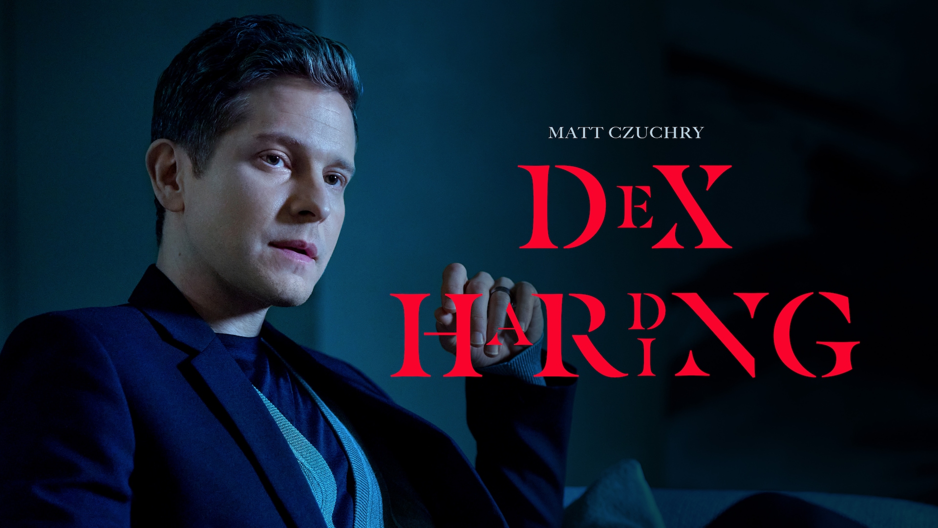 Matt Czuchry headshot wearing a navy suit sitting against a gray background for AHS: Delicate