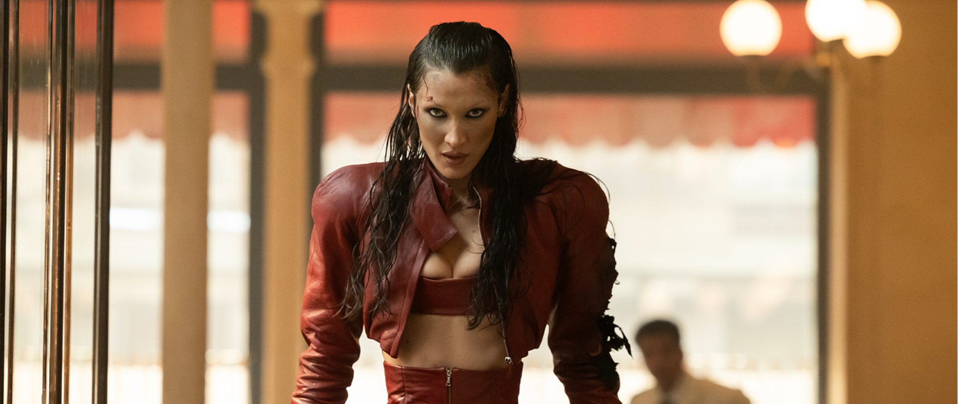 Close up of Bella Hadid in a red matching set with slicked back hair