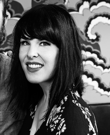 Alexis Martin Woodall wearing black and white floral top in black and white headshot