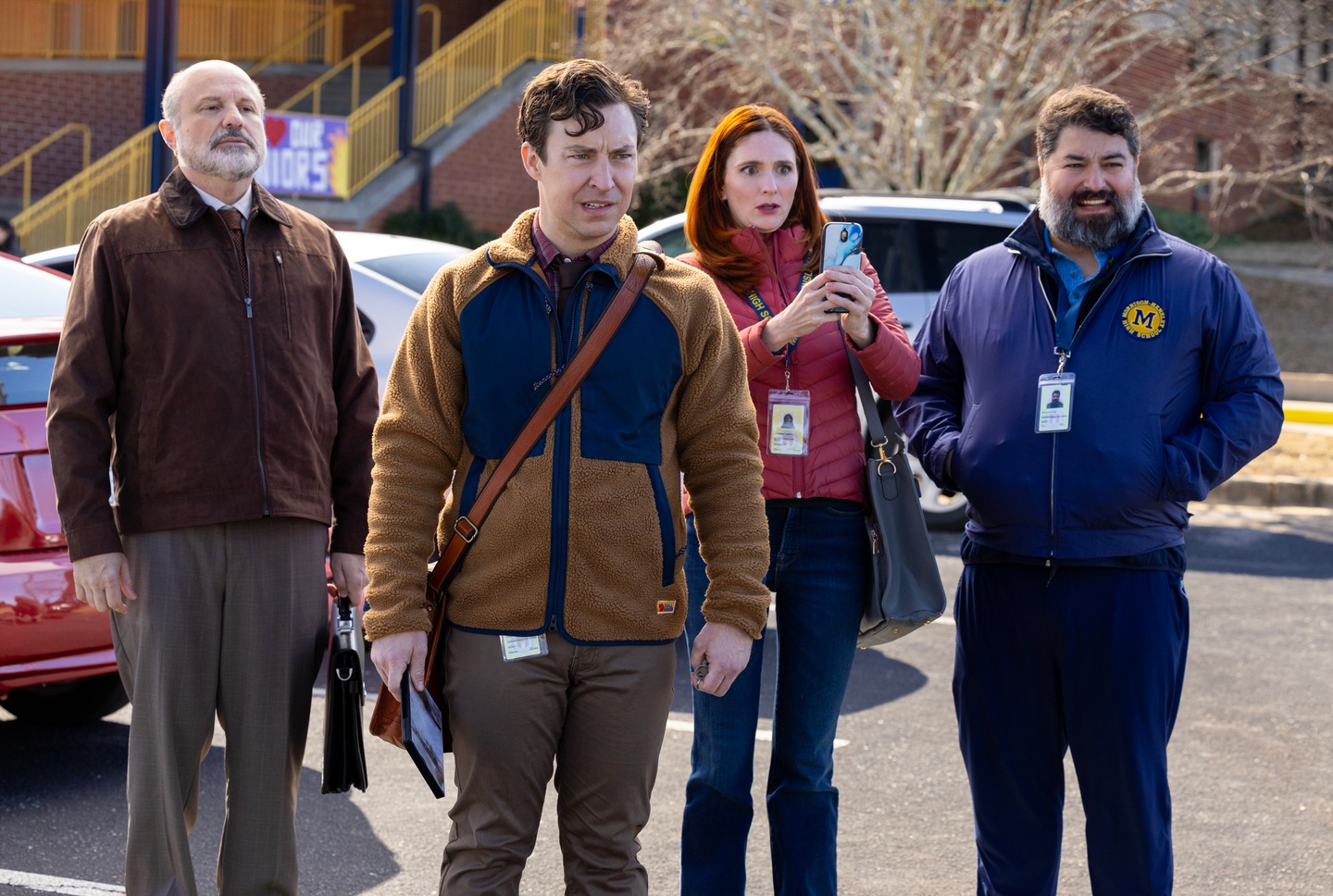 Cast of FX's English Teacher standing in a parking lot