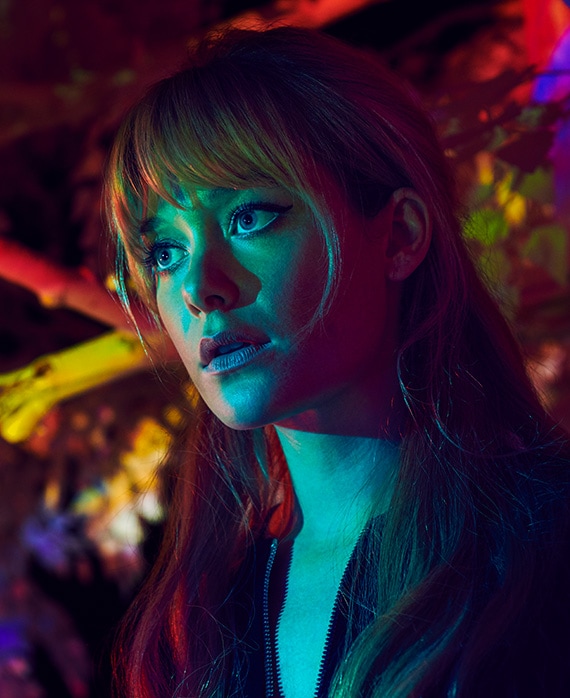 Rachel Keller as Syd in FX's Legion, in a black zip jacket, with teal light shining on face