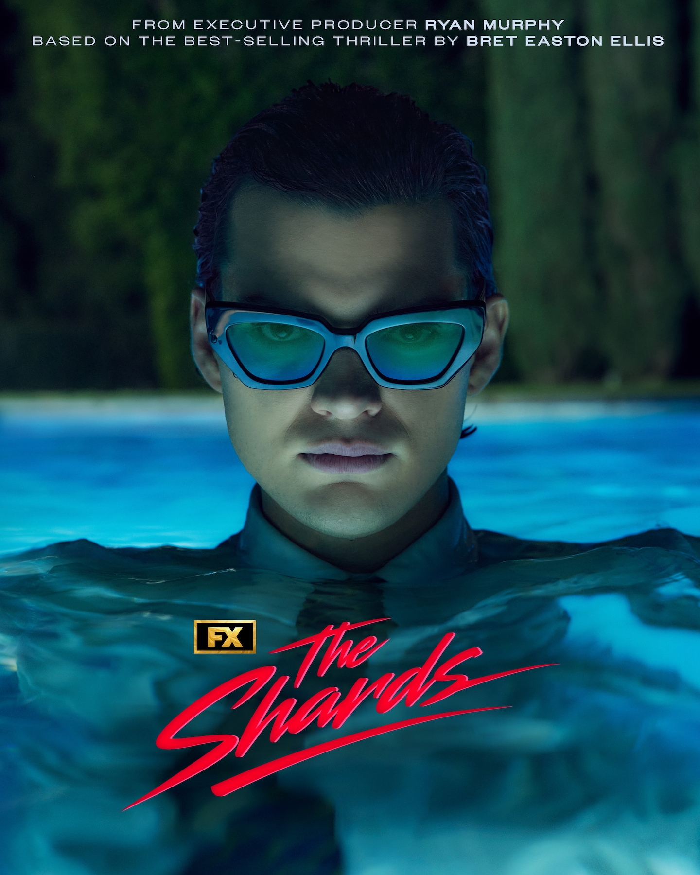 FX's The Shards Homer Gere, wearing a full suit and sunglasses underwater in a pool.