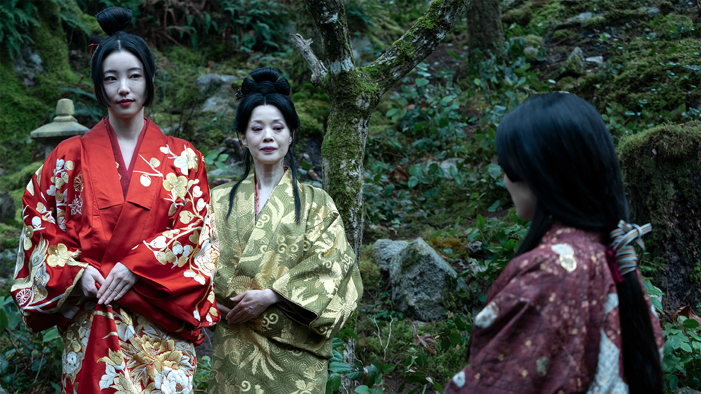 Courtesans Kiku and Gin stand facing Lady Mariko in Ajiro Village on FX’s Shogun